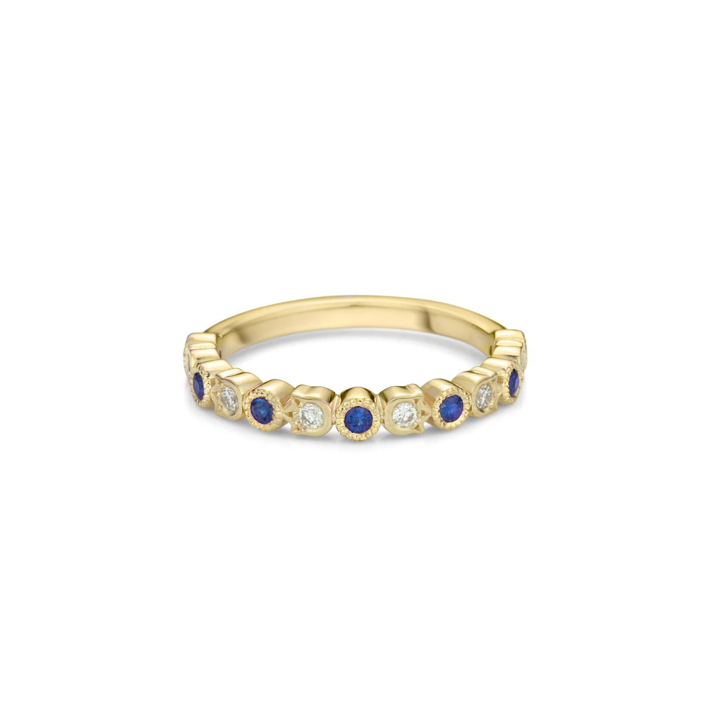 A yellow gold band style ring set half way with alternating fine sapphires in round bezels with millegrain and diamonds in flower shaped bezels.