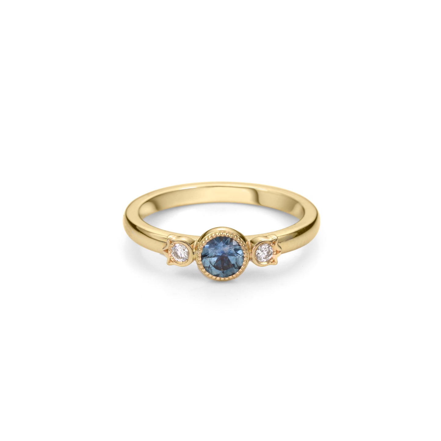 Yellow gold stackable ring with round beaded bezel set Montana blue sapphire and diamonds in flower setting on each side.