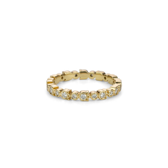 Load image into Gallery viewer, A yellow gold and diamond full eternity band ring set with diamonds in alternating round and flower shaped bezels.
