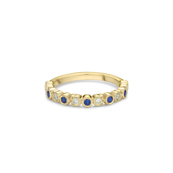 A yellow gold band style ring set half way with alternating fine sapphires in round bezels with millegrain and diamonds in flower shaped bezels.